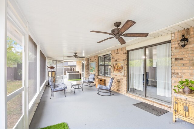 unfurnished sunroom featuring a healthy amount of sunlight and ceiling fan