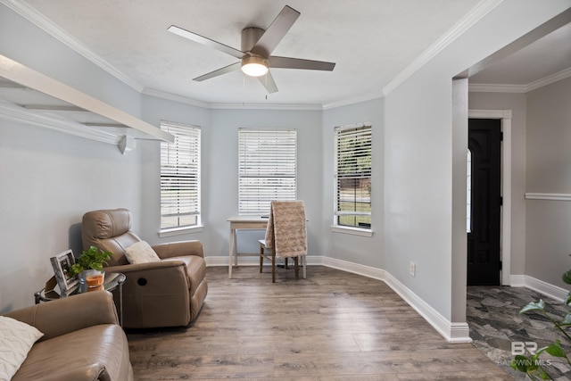 sitting room with ornamental molding, dark wood-type flooring, and ceiling fan