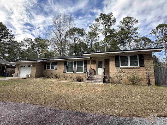 ranch-style home featuring an attached garage, fence, and brick siding