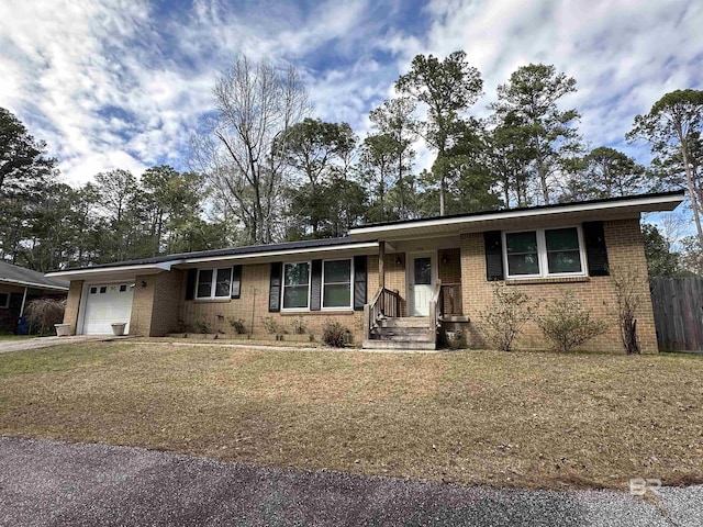 ranch-style home with a garage, driveway, fence, and brick siding