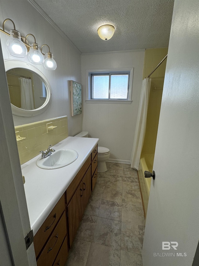 bathroom with decorative backsplash, toilet, vanity, crown molding, and a textured ceiling