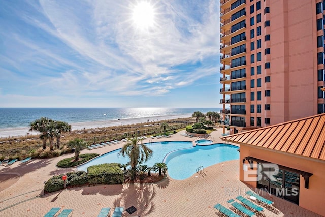 view of swimming pool with a water view