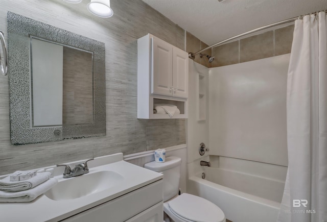 full bath with a textured ceiling, vanity, shower / bath combination with curtain, and toilet