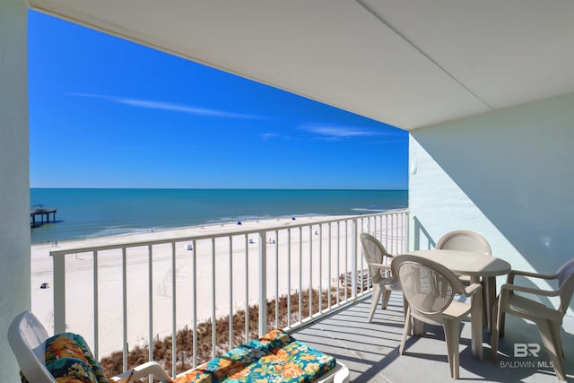 balcony with a water view and a beach view