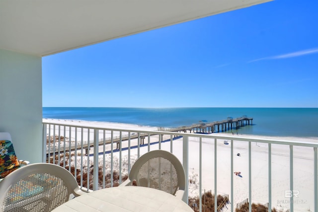 balcony featuring a water view and a view of the beach