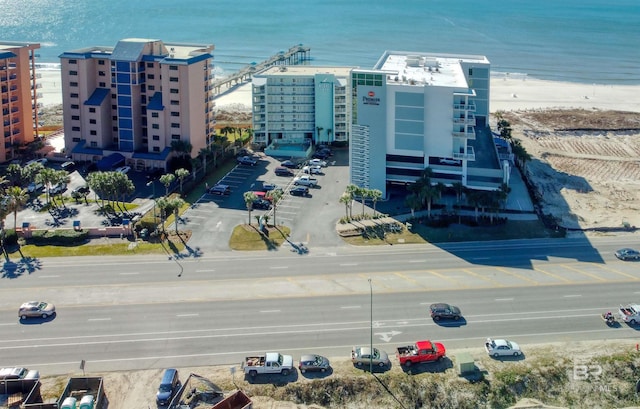 drone / aerial view with a water view and a view of the beach