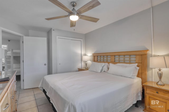 bedroom with light tile patterned floors, ceiling fan, and a closet