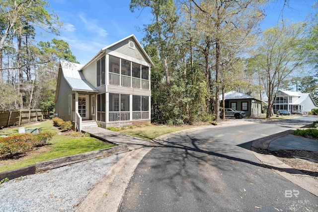 25773 Canal Rd Unit 28, Orange Beach, AL 36561 - view of front of house featuring fence, a front yard, and a sunroom