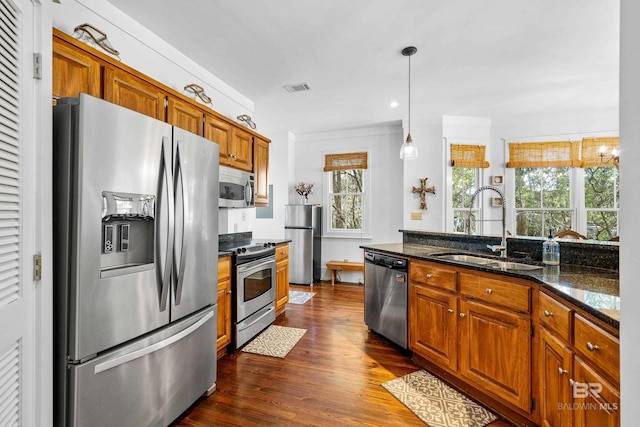 25773 Canal Rd Unit 28, Orange Beach, AL 36561 - kitchen featuring visible vents, dark wood-type flooring, brown cabinets, stainless steel appliances, and a sink