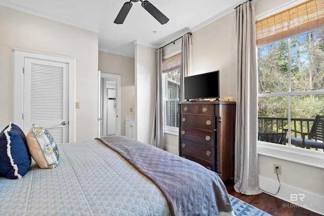 25773 Canal Rd Unit 28, Orange Beach, AL 36561 - bedroom with baseboards, a ceiling fan, and wood finished floors