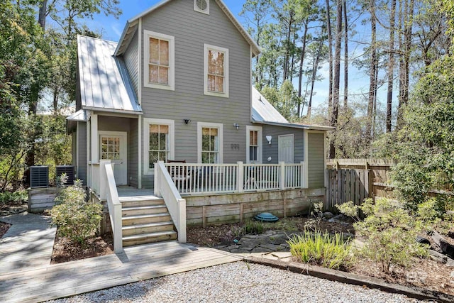 25773 Canal Rd Unit 28, Orange Beach, AL 36561 - view of front of home with metal roof, central air condition unit, a wooden deck, and fence