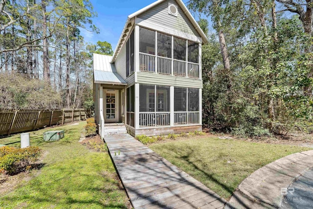 25773 Canal Rd Unit 28, Orange Beach, AL 36561 - rear view of property with a yard, fence, and a sunroom