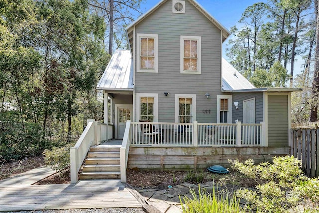 25773 Canal Rd Unit 28, Orange Beach, AL 36561 - traditional-style house with a deck, fence, and metal roof