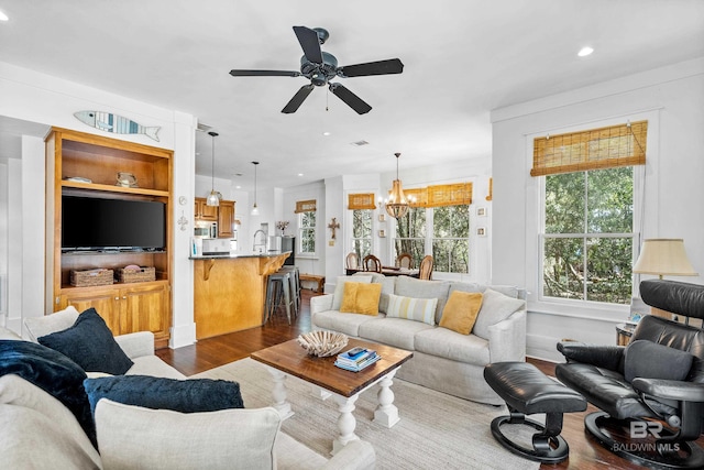 25773 Canal Rd Unit 28, Orange Beach, AL 36561 - living room with dark wood-style floors, plenty of natural light, ceiling fan with notable chandelier, and recessed lighting