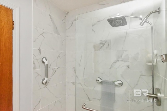 bathroom with a tile shower