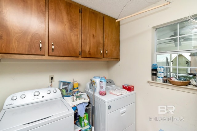 washroom featuring cabinets, a textured ceiling, and independent washer and dryer