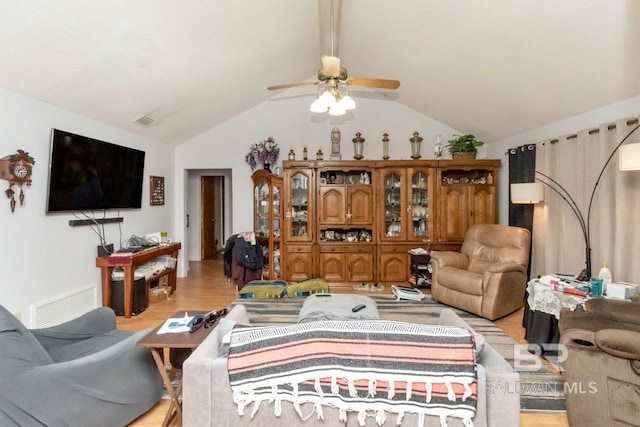 living room with ceiling fan, lofted ceiling, and light hardwood / wood-style flooring