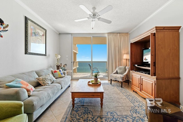 living room featuring light tile patterned floors, ornamental molding, floor to ceiling windows, and a textured ceiling