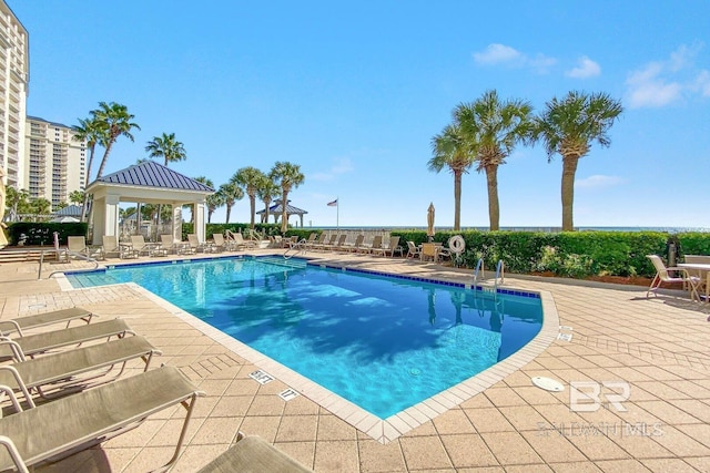 pool with a gazebo and a patio area