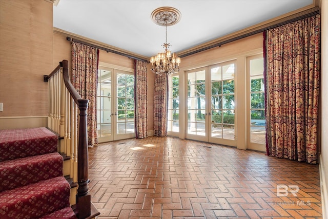 entryway featuring french doors, a notable chandelier, and a wealth of natural light