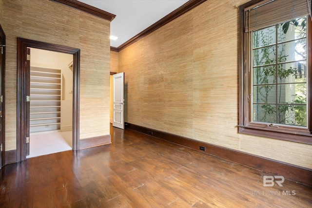 unfurnished room with crown molding and hardwood / wood-style flooring