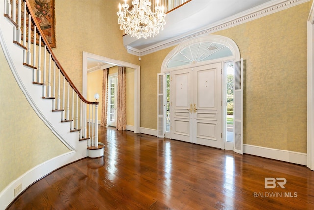 foyer featuring crown molding, plenty of natural light, and dark hardwood / wood-style flooring