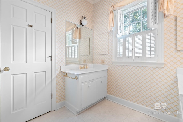 bathroom featuring tile patterned flooring, vanity, and a healthy amount of sunlight