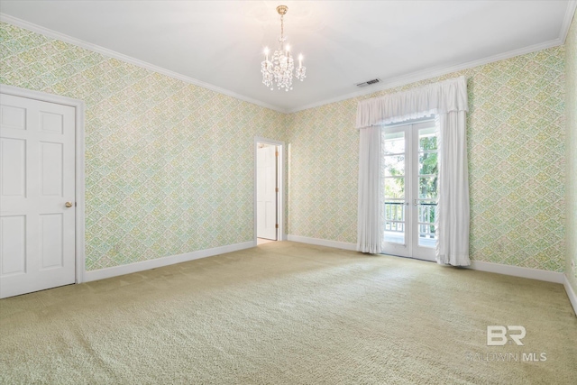 spare room with light carpet, a notable chandelier, french doors, and ornamental molding