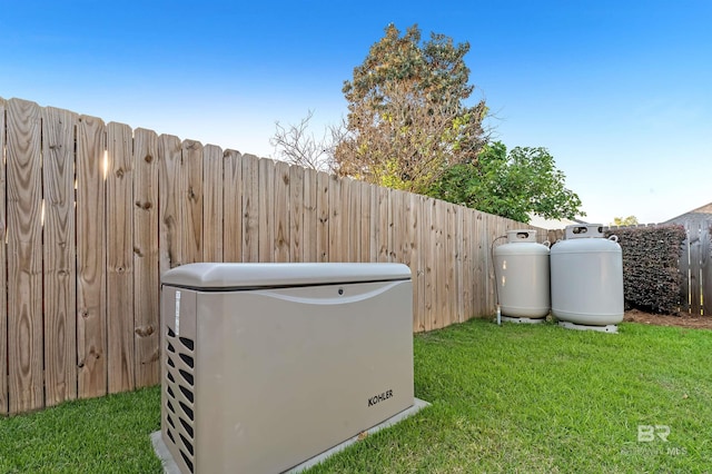 exterior details with heating fuel, a power unit, and a fenced backyard