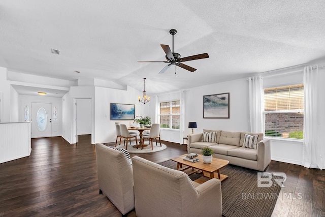 living room with vaulted ceiling, wood finished floors, a textured ceiling, ceiling fan with notable chandelier, and visible vents