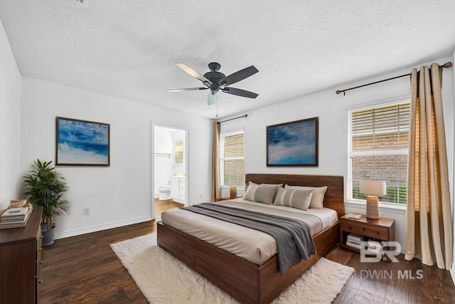 bedroom with wood finished floors, a textured ceiling, and multiple windows