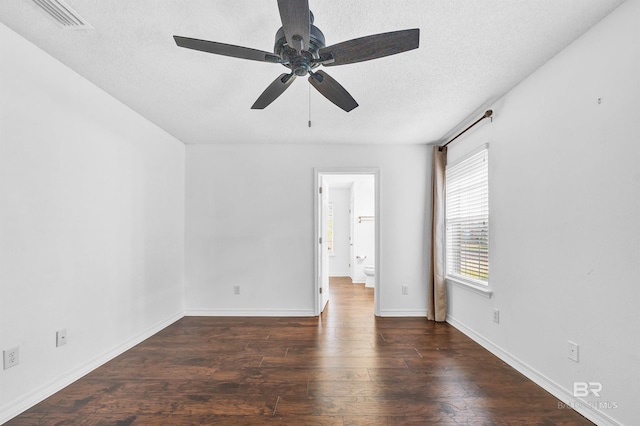 unfurnished room with wood finished floors, visible vents, baseboards, a textured ceiling, and ceiling fan