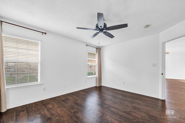 unfurnished room with baseboards, wood finished floors, and ceiling fan