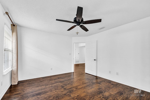 unfurnished bedroom featuring baseboards, wood finished floors, visible vents, and ceiling fan