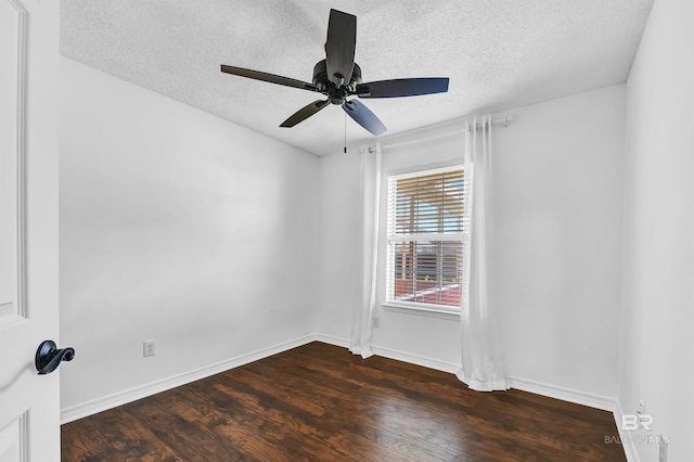 spare room with dark wood finished floors, a textured ceiling, a ceiling fan, and baseboards