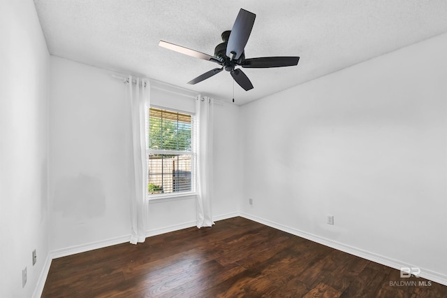 unfurnished room with baseboards, a ceiling fan, wood finished floors, and a textured ceiling