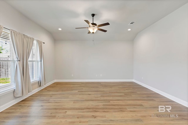 spare room with light wood-type flooring, baseboards, ceiling fan, and recessed lighting