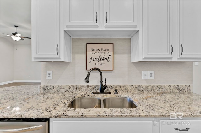 kitchen with a ceiling fan, a sink, white cabinetry, backsplash, and dishwasher