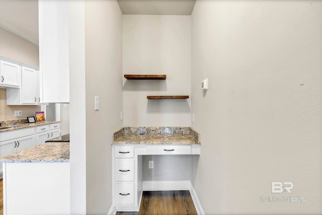 interior space with baseboards and wood finished floors