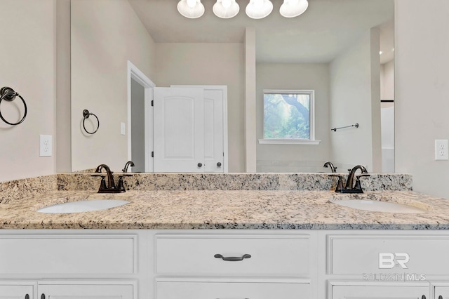 full bathroom featuring a sink and double vanity