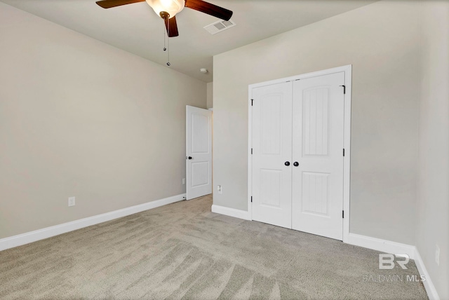unfurnished bedroom with a ceiling fan, a closet, baseboards, carpet flooring, and visible vents