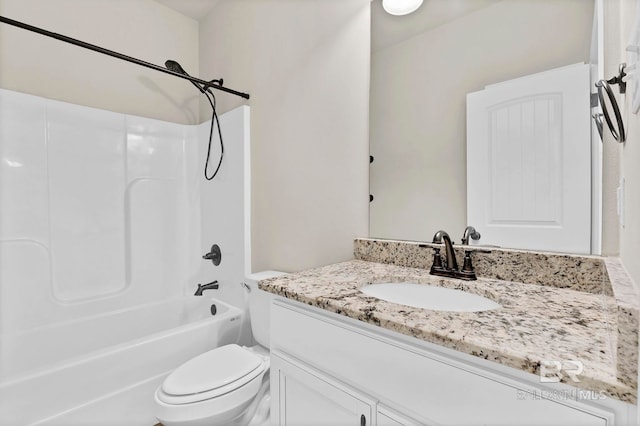 bathroom featuring toilet, vanity, and tub / shower combination