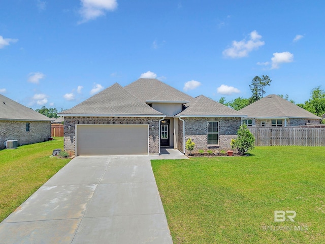 ranch-style home with an attached garage, fence, central air condition unit, a front yard, and brick siding