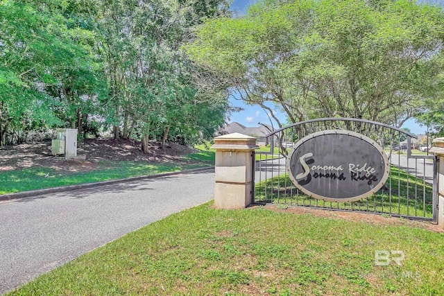 community sign featuring a yard