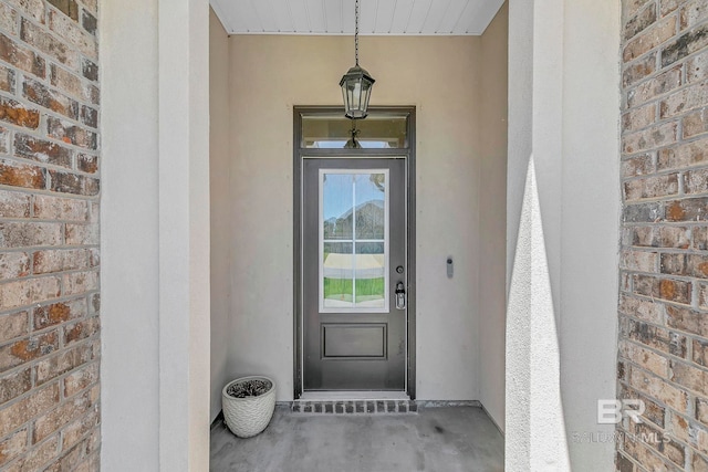 entrance to property with stucco siding