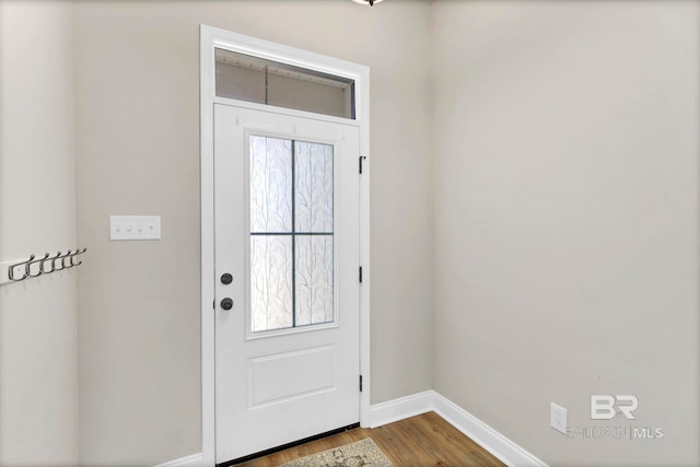 doorway to outside with baseboards and dark wood-type flooring