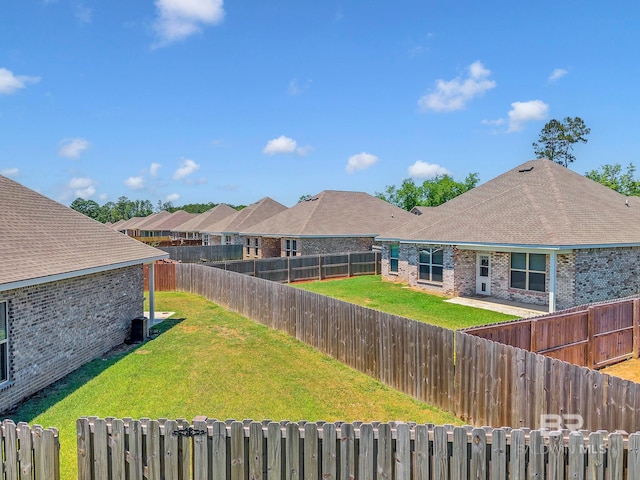 view of yard with a fenced backyard