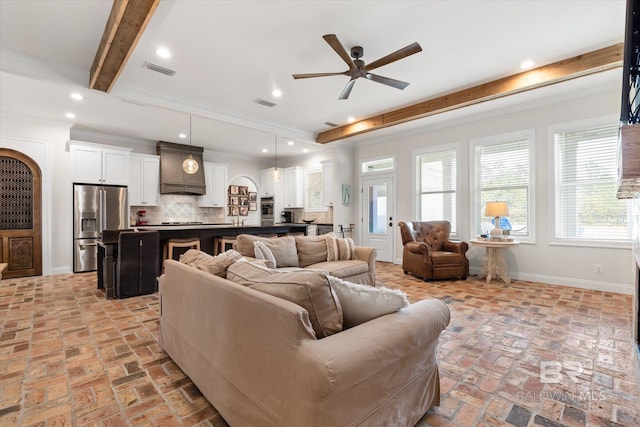 living room with crown molding, ceiling fan, and beam ceiling