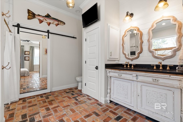 bathroom with crown molding, vanity, and toilet