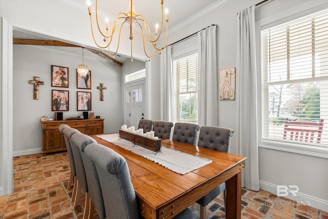 dining space with crown molding and a notable chandelier